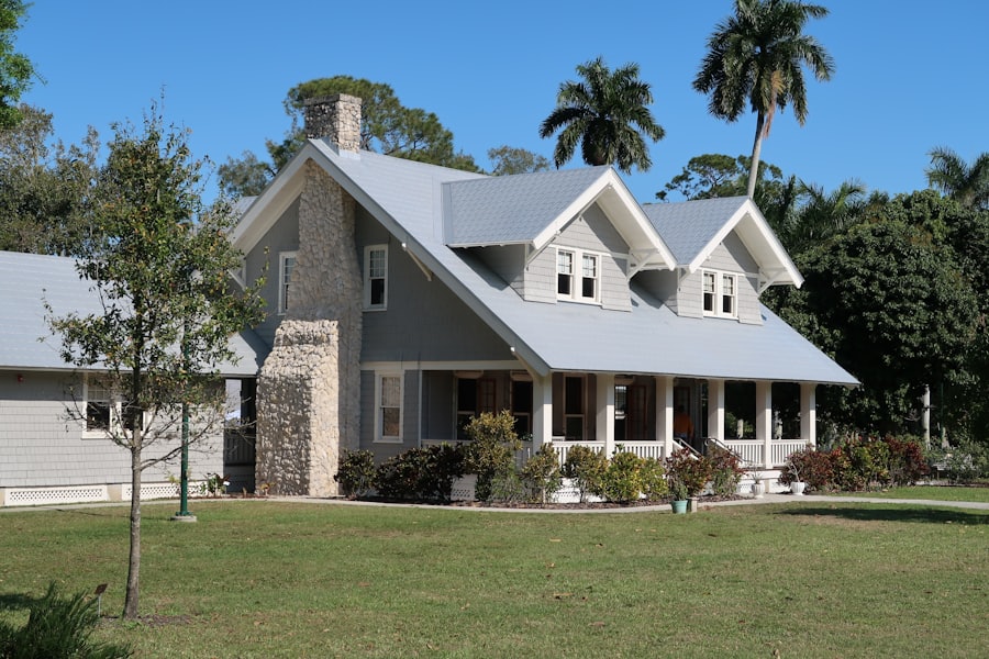 Technician soft-washing a home exterior